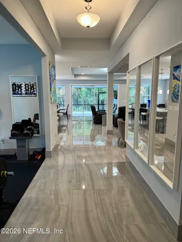 a view of a hallway view with wooden floor and furniture