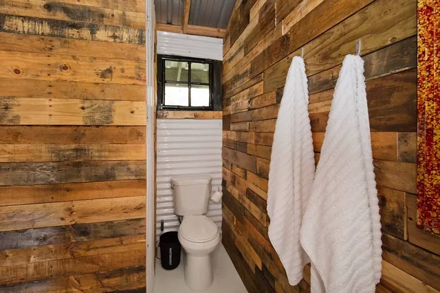 a bathroom with a toilet and shower