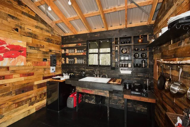 a kitchen with stainless steel appliances kitchen island granite countertop a sink and cabinets