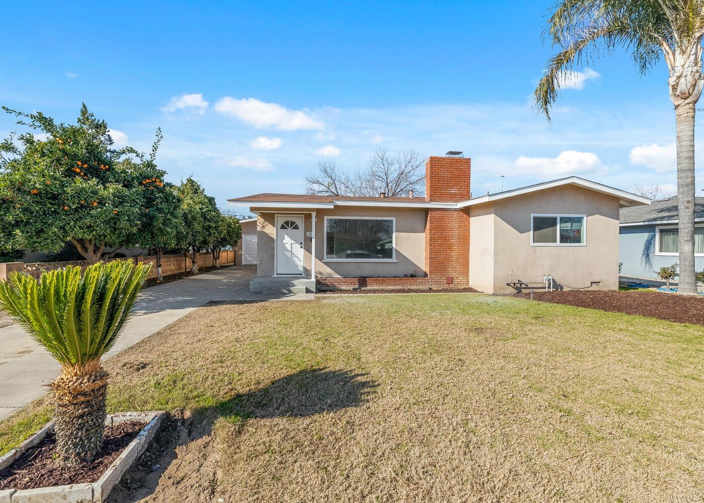 1265 South Klein Avenue Reedley, CA 93654 - Photo 1 of 31 a front view of a house with garden