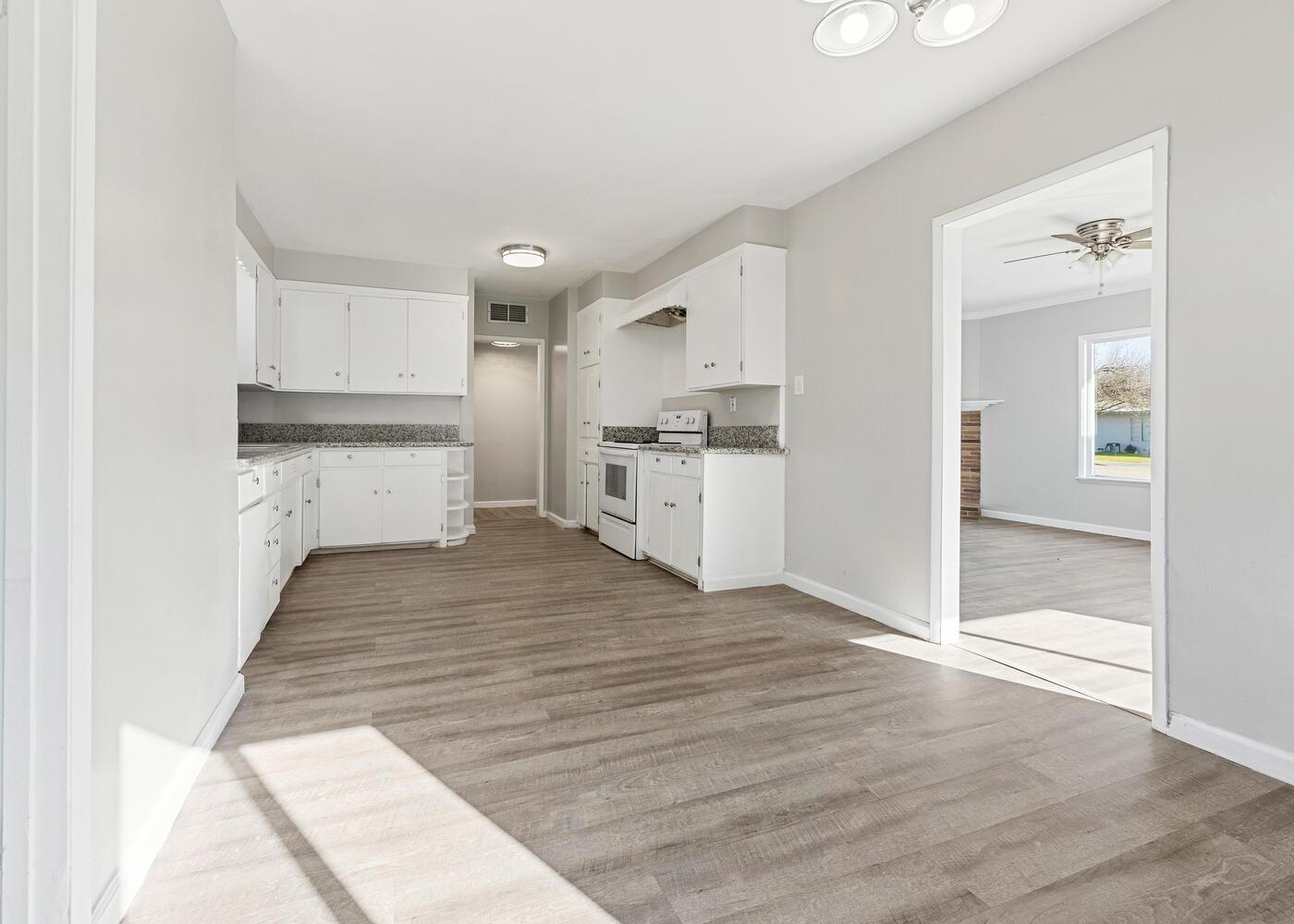 1265 South Klein Avenue Reedley, CA 93654 - Photo 12 of 31 a view of a kitchen with wooden floor and a sink