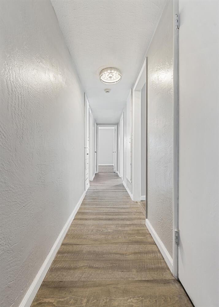 1265 South Klein Avenue Reedley, CA 93654 - Photo 18 of 31 a view of a hallway with wooden floor