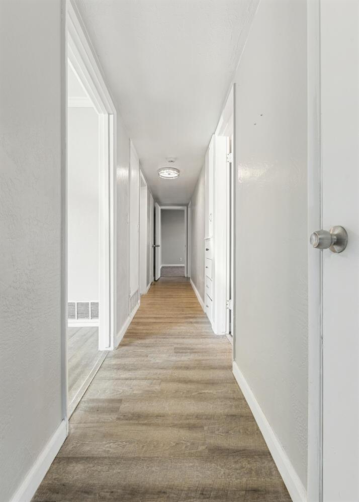 1265 South Klein Avenue Reedley, CA 93654 - Photo 19 of 31 a view of a hallway with wooden floor