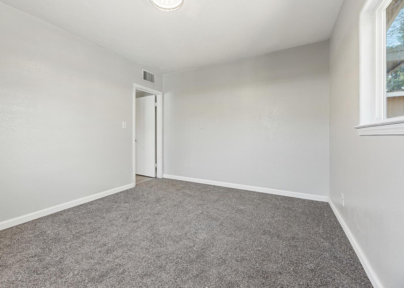 1265 South Klein Avenue Reedley, CA 93654 - Photo 25 of 31 an empty room with windows and closet