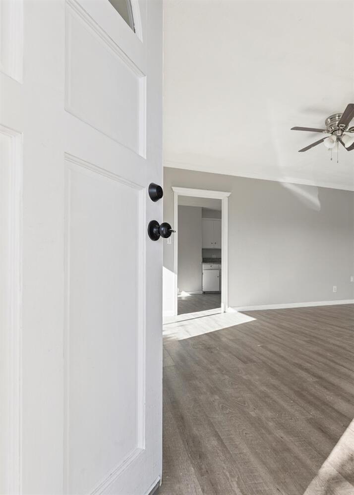 1265 South Klein Avenue Reedley, CA 93654 - Photo 5 of 31 a view of an empty room with wooden floor and a window