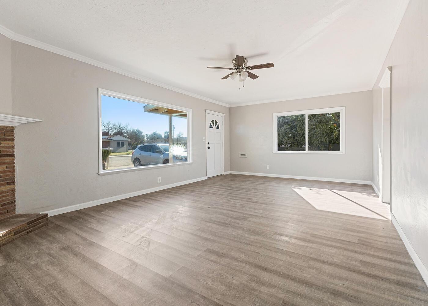 1265 South Klein Avenue Reedley, CA 93654 - Photo 8 of 31 a view of an empty room with a window and wooden floor