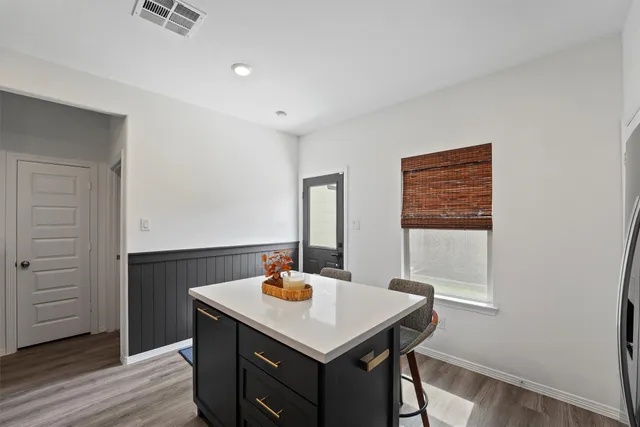 a kitchen with a table and chairs
