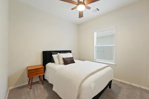 a bedroom with a bed and a chandelier