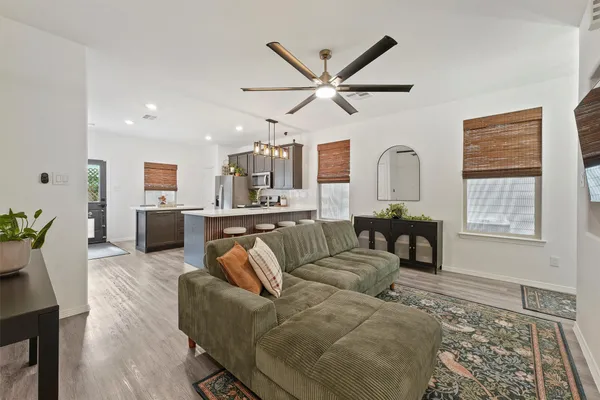 a living room with furniture and kitchen view