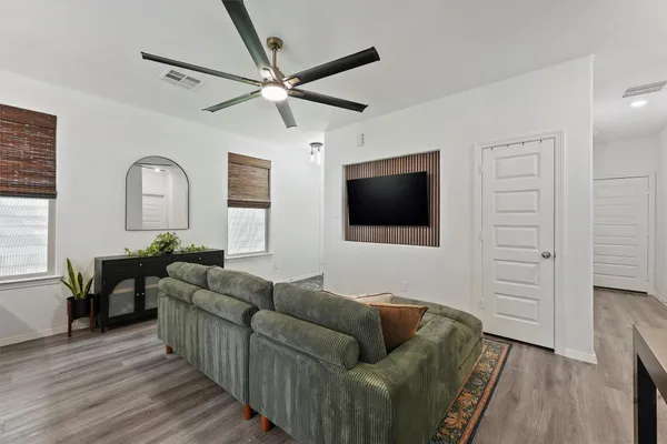 a living room with furniture and a flat screen tv