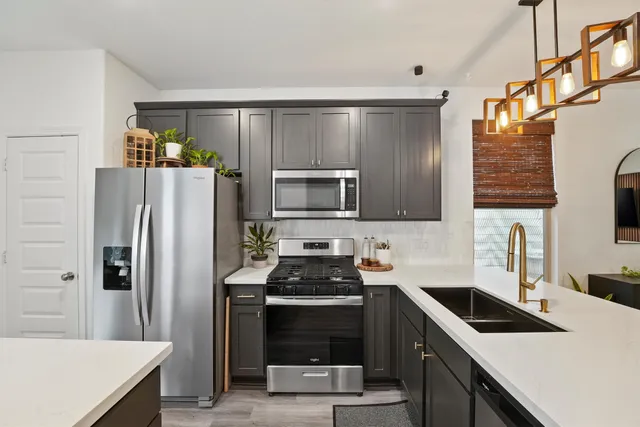 a kitchen with a sink a stove and refrigerator
