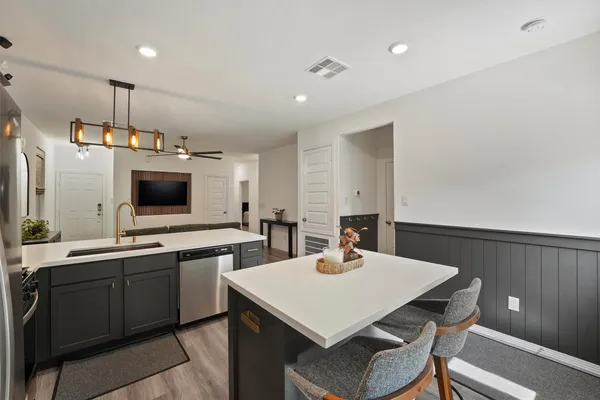 a kitchen with a sink a table and chairs