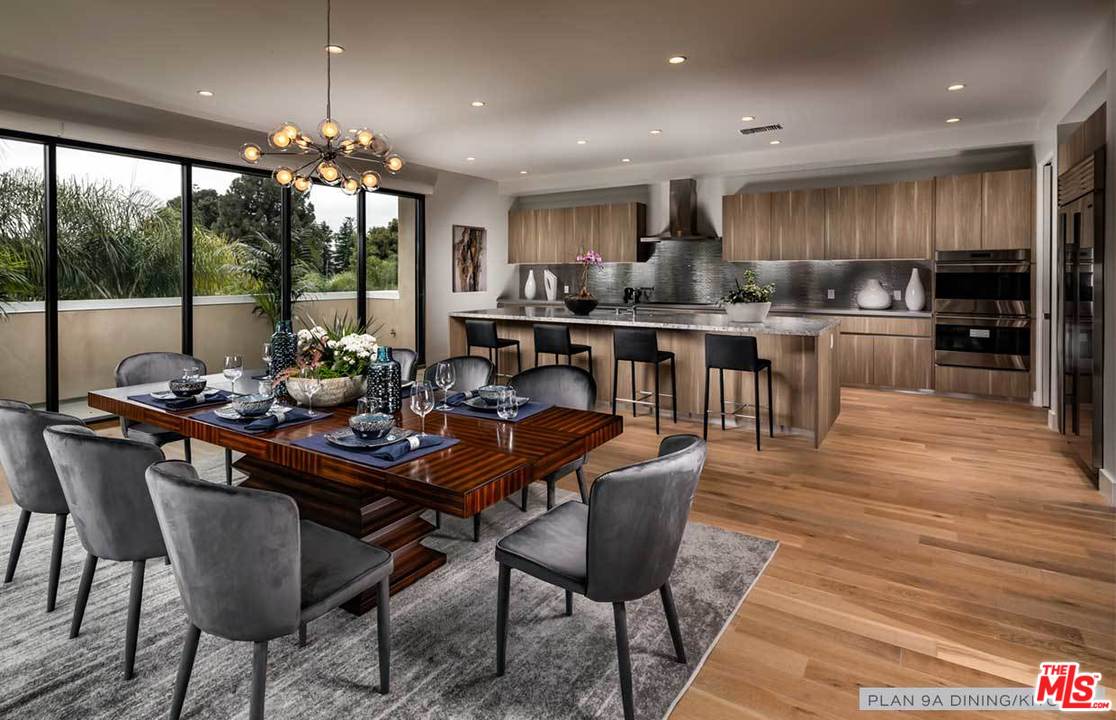 a kitchen with a dining table chairs and stove