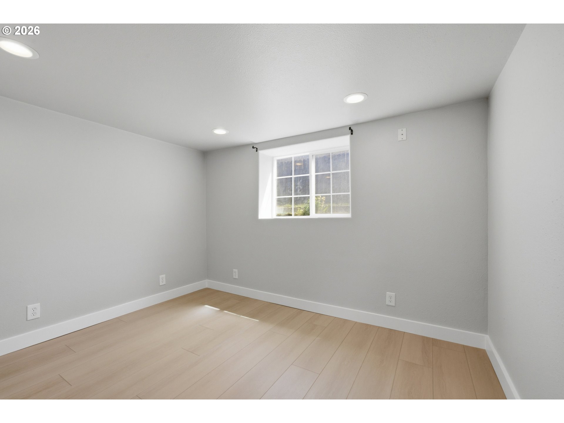 1802 8th Street Tillamook, OR 97141 - Photo 29 of 37 an empty room with wooden floor and windows