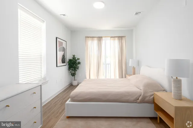 a bedroom with a bed and a window