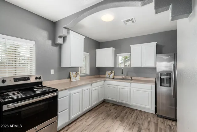 a kitchen with a sink stove and cabinets