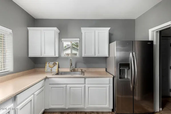 a kitchen with stainless steel appliances granite countertop a refrigerator and a sink