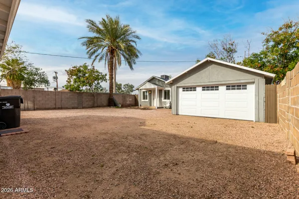 a view of a house with a yard and garage