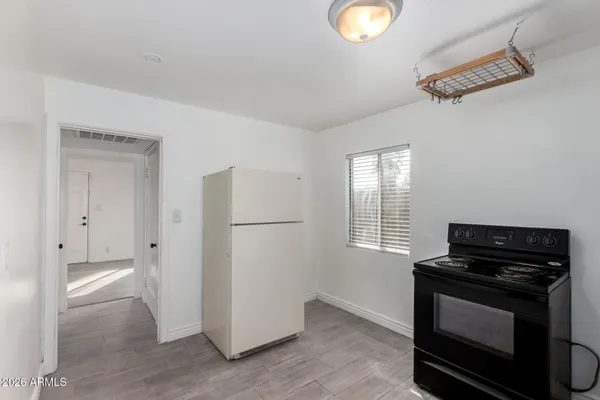 a kitchen with a refrigerator and a stove top oven
