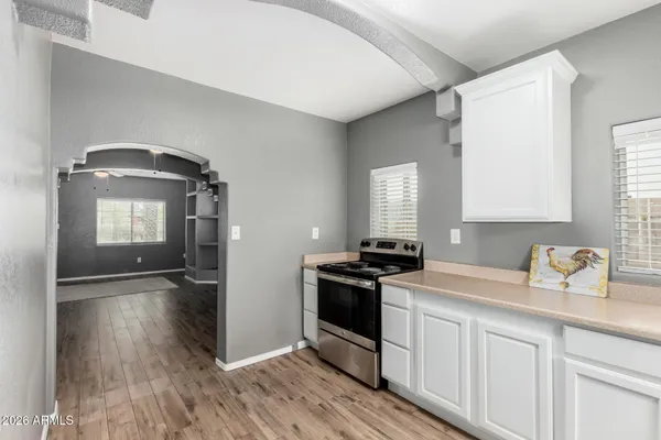 a kitchen with a sink stove and cabinets