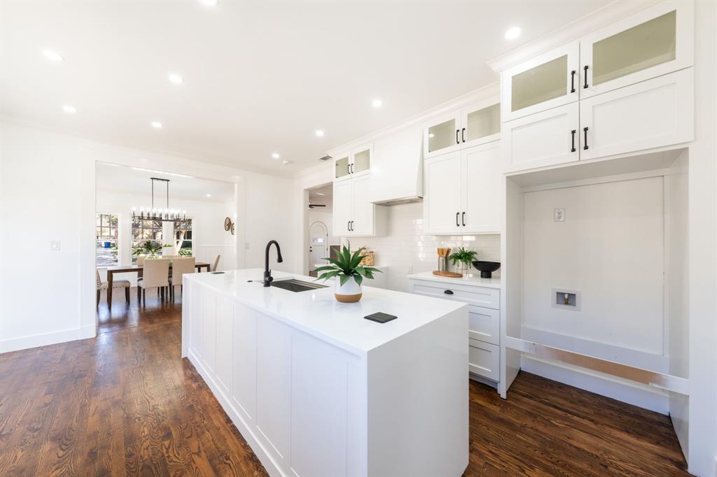 713 Ridgeway Street Dallas, TX 75214 - Photo 15 of 29 a view of a kitchen with kitchen island a sink a center island stainless steel appliances and a dining table