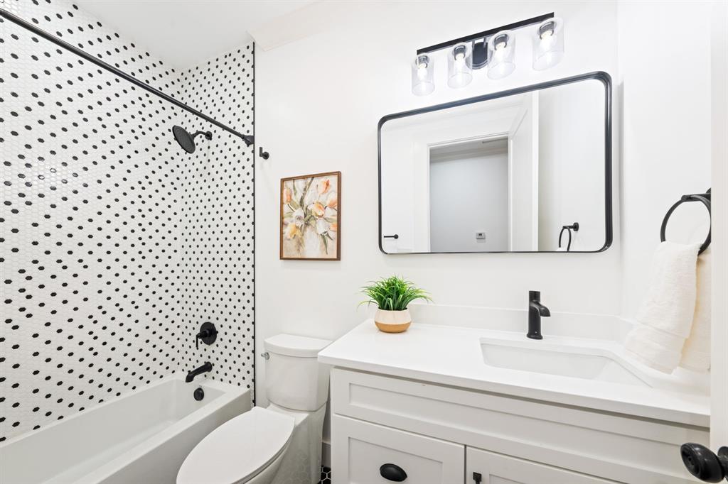 713 Ridgeway Street Dallas, TX 75214 - Photo 18 of 29 a bathroom with a sink a toilet and a mirror