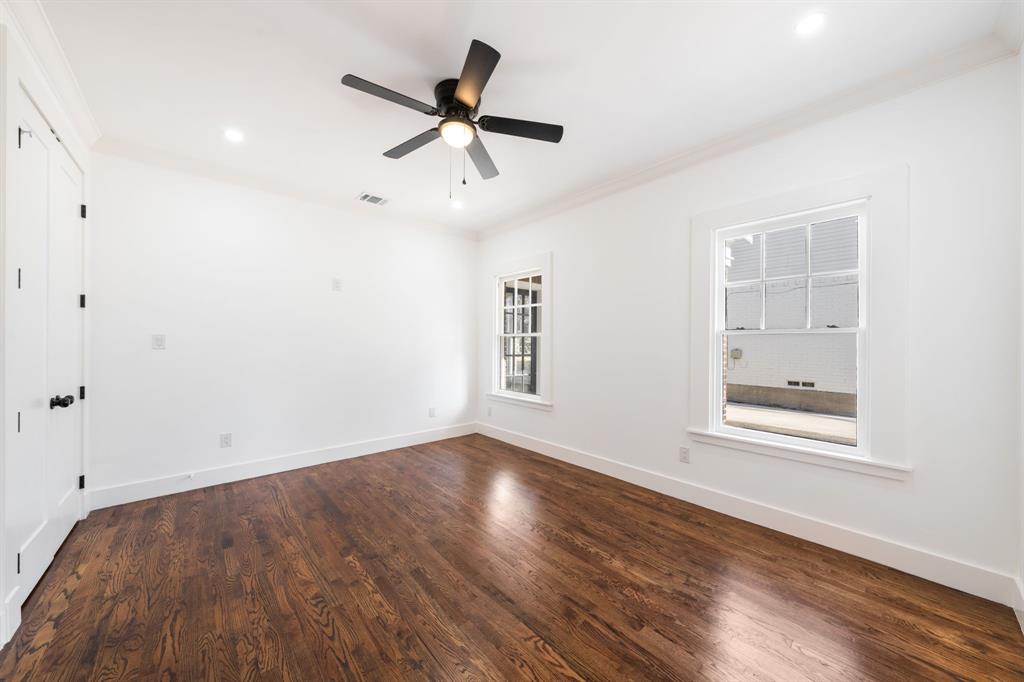 713 Ridgeway Street Dallas, TX 75214 - Photo 20 of 29 an empty room with wooden floor fan and windows