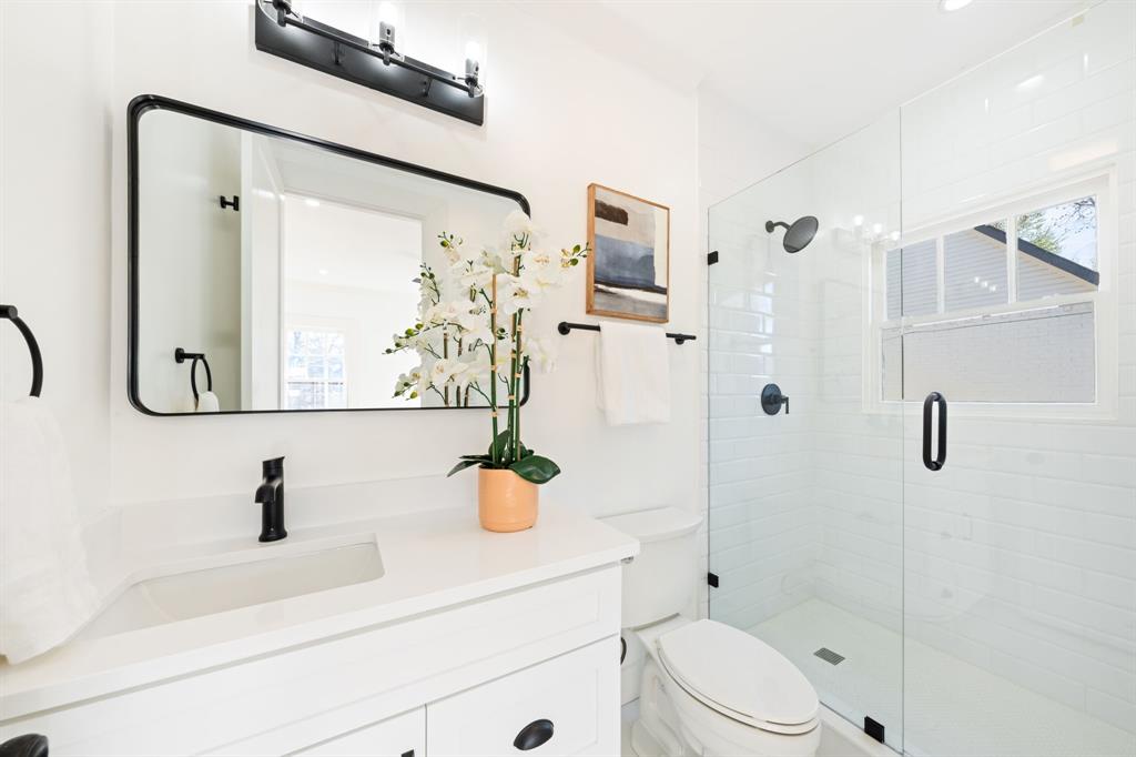 713 Ridgeway Street Dallas, TX 75214 - Photo 22 of 29 a bathroom with a sink a toilet and shower