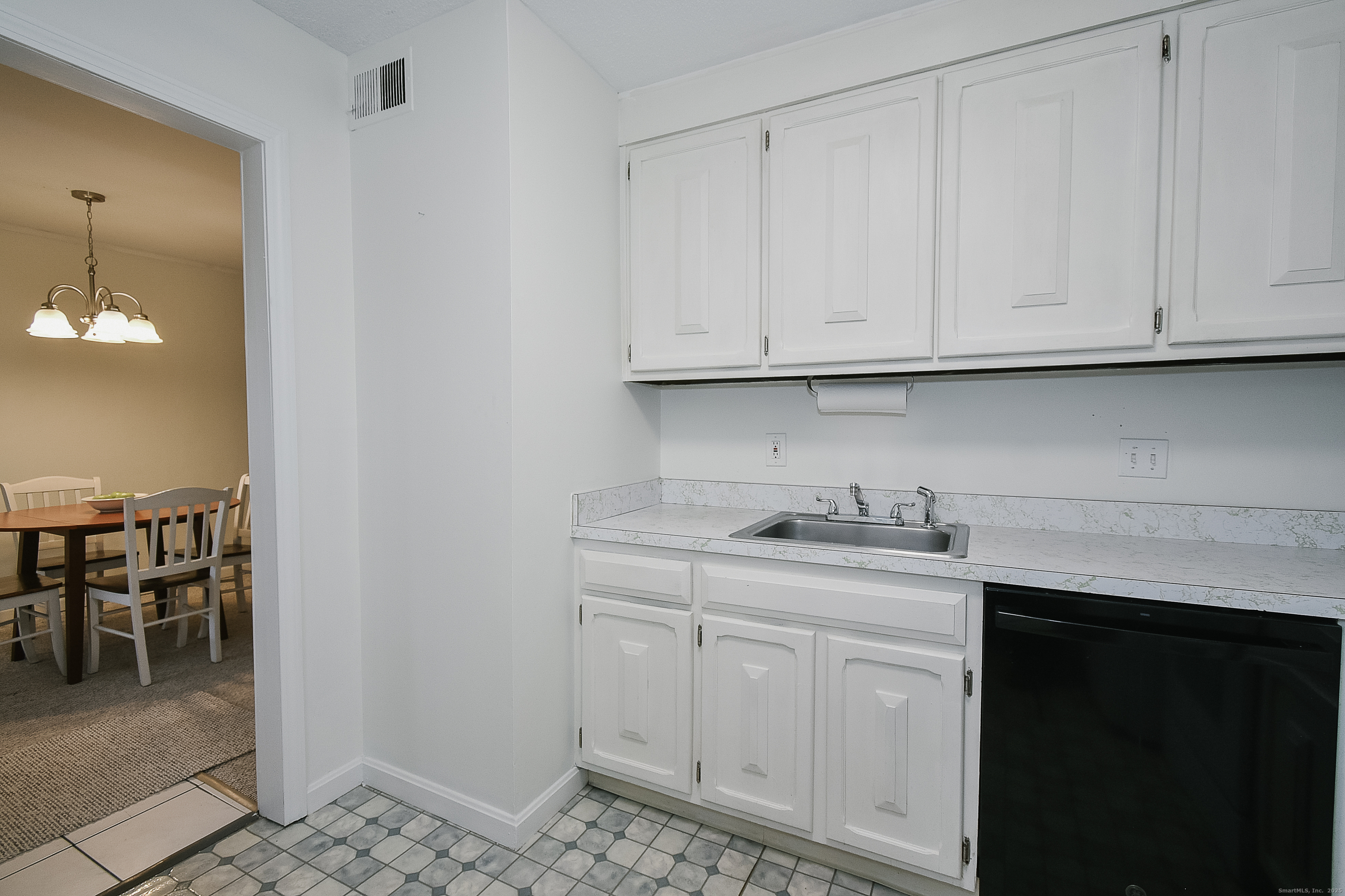 4 Georgetown Drive, Unit A Enfield, CT 06082 - Photo 13 of 20 a kitchen with white cabinets and sink