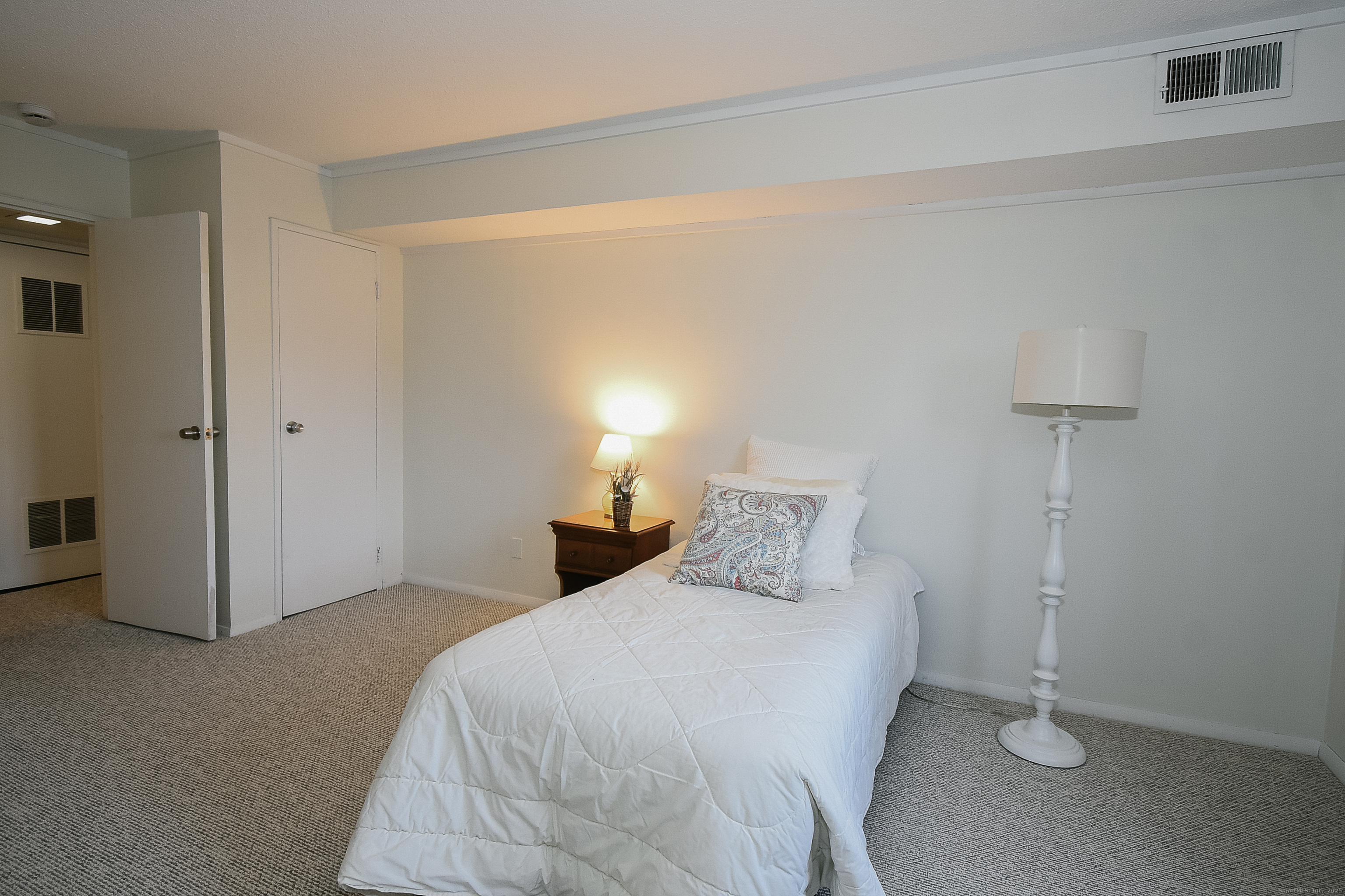 4 Georgetown Drive, Unit A Enfield, CT 06082 - Photo 9 of 20 a bedroom with a bed and a night stand