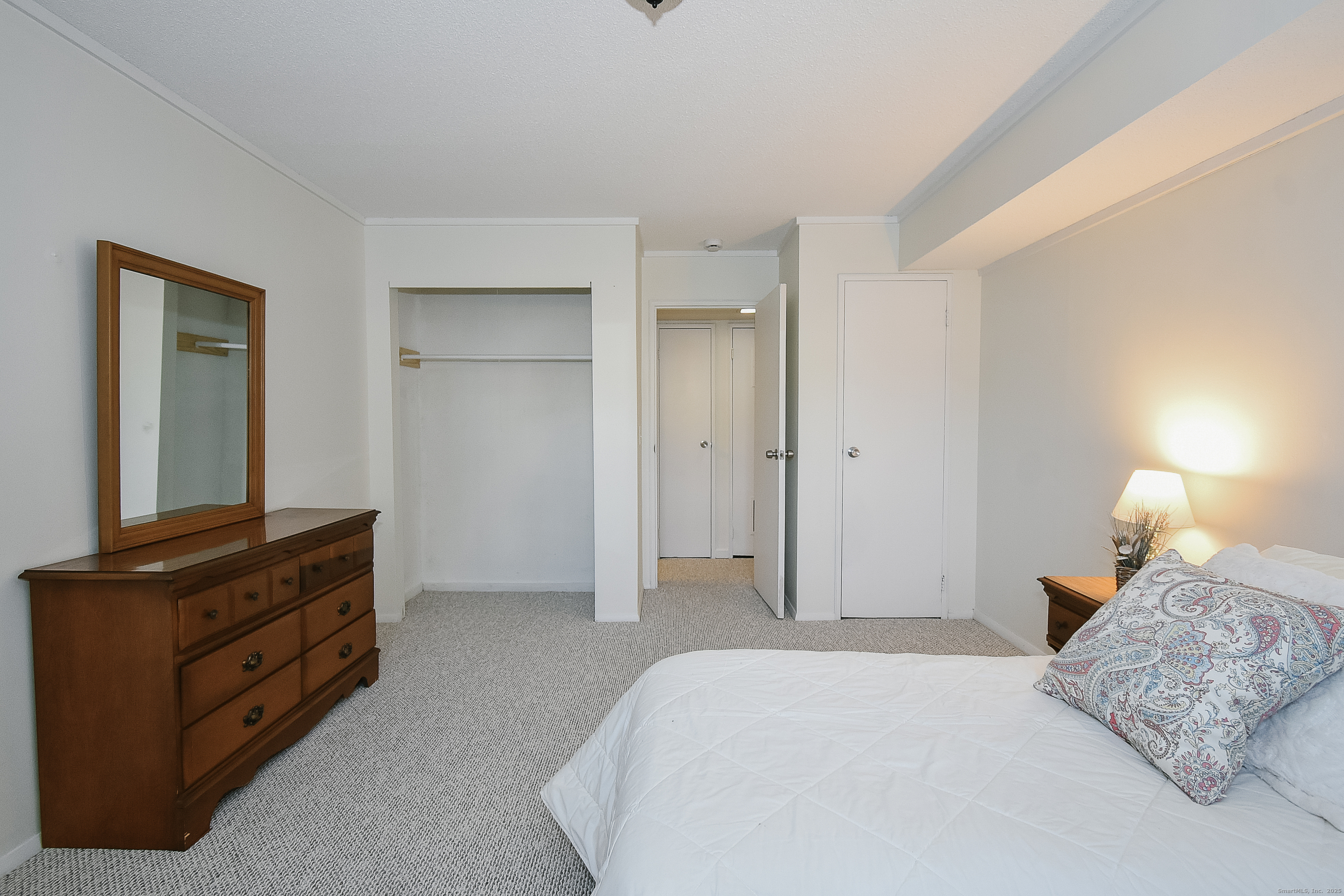 4 Georgetown Drive, Unit A Enfield, CT 06082 - Photo 10 of 20 a bedroom with a bed and a mirror on dresser