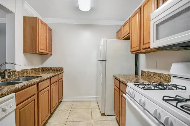 a kitchen with stainless steel appliances granite countertop a stove and a refrigerator