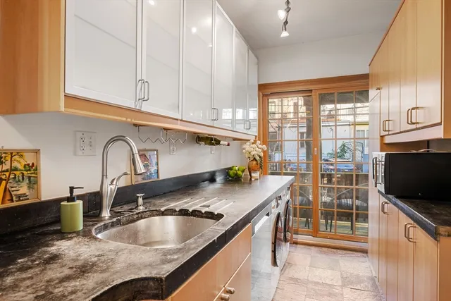 a kitchen with granite countertop a sink and a stove top oven