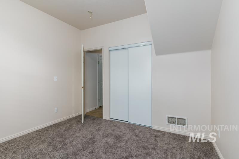 204 La Valle Strada Pocatello, ID 83201 - Photo 12 of 23 Unfurnished bedroom featuring carpet floors and a closet
