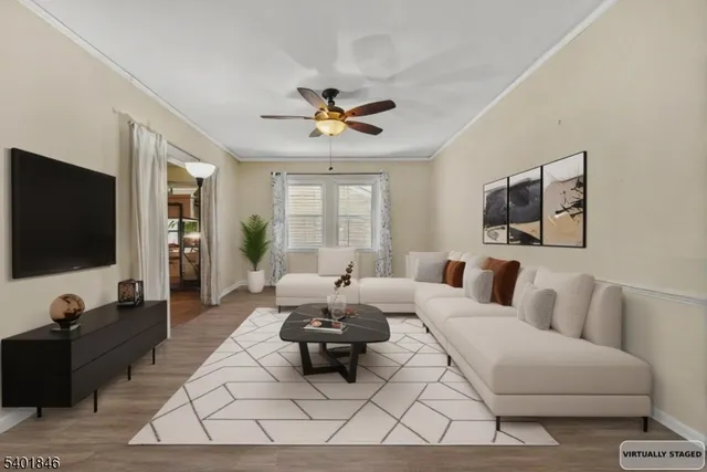 a living room with furniture a flat screen tv and a large window