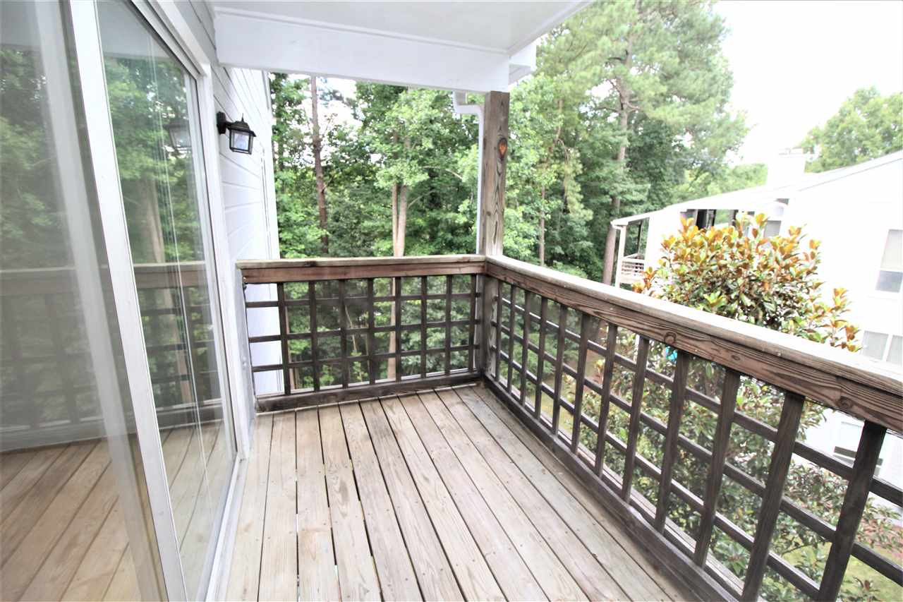 4621 Timbermill Court, Unit 301 Raleigh, NC 27612 - Photo 22 of 24 The deck off the living room is the perfect place to enjoy your morning coffee or evening cocktail! Enjoy relaxing after a hard days work and take in the beautiful green scenery! Deck off Living Room