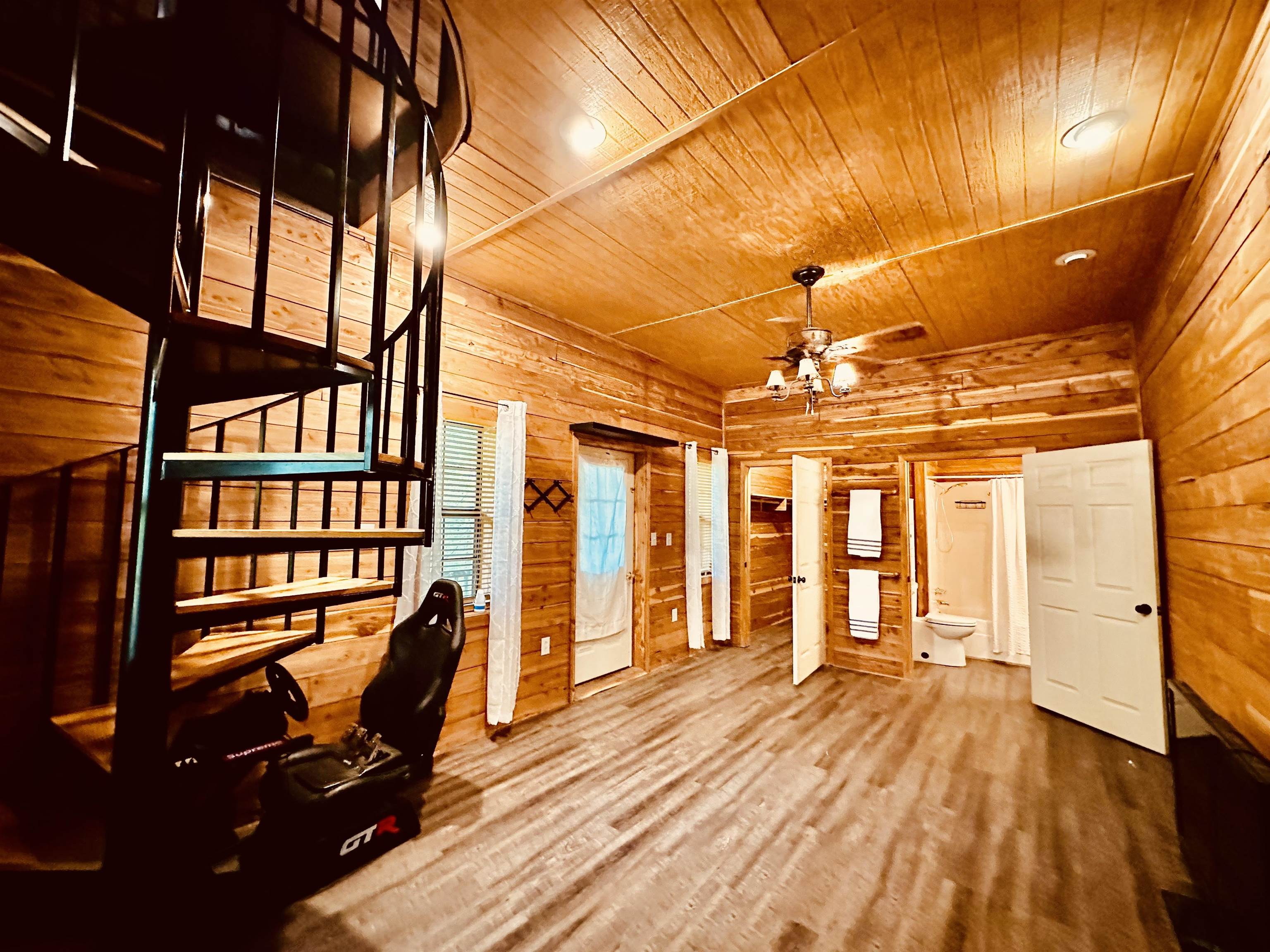 25 Kerr Lane Savannah, TN 38372 - Photo 27 of 36 Spiral staircase with black metal railing, wood-finish flooring, wood plank walls, and wood plank ceiling with recessed lighting and a ceiling fan