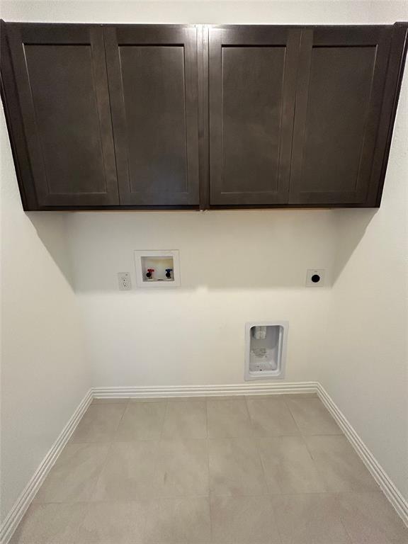 1448 Sun Gdn Way Justin, TX 76247 - Photo 26 of 28 Laundry area with washer hookup, cabinet space, and electric dryer hookup