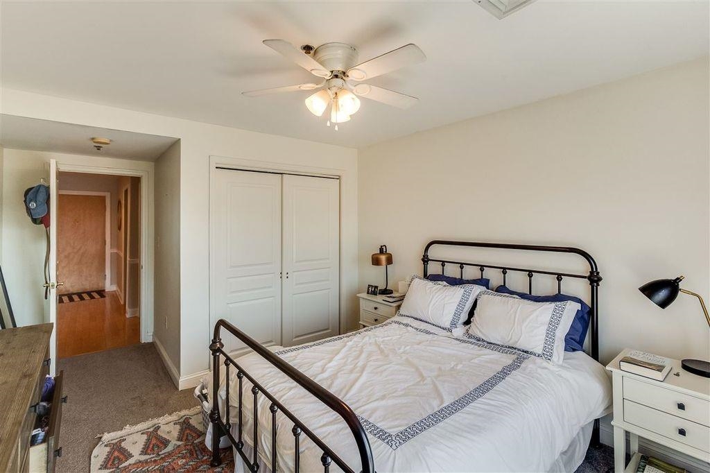 711 Clinton Street, Unit 6A Hoboken, NJ 07030 - Photo 12 of 15 a bedroom with a bed and a chandelier