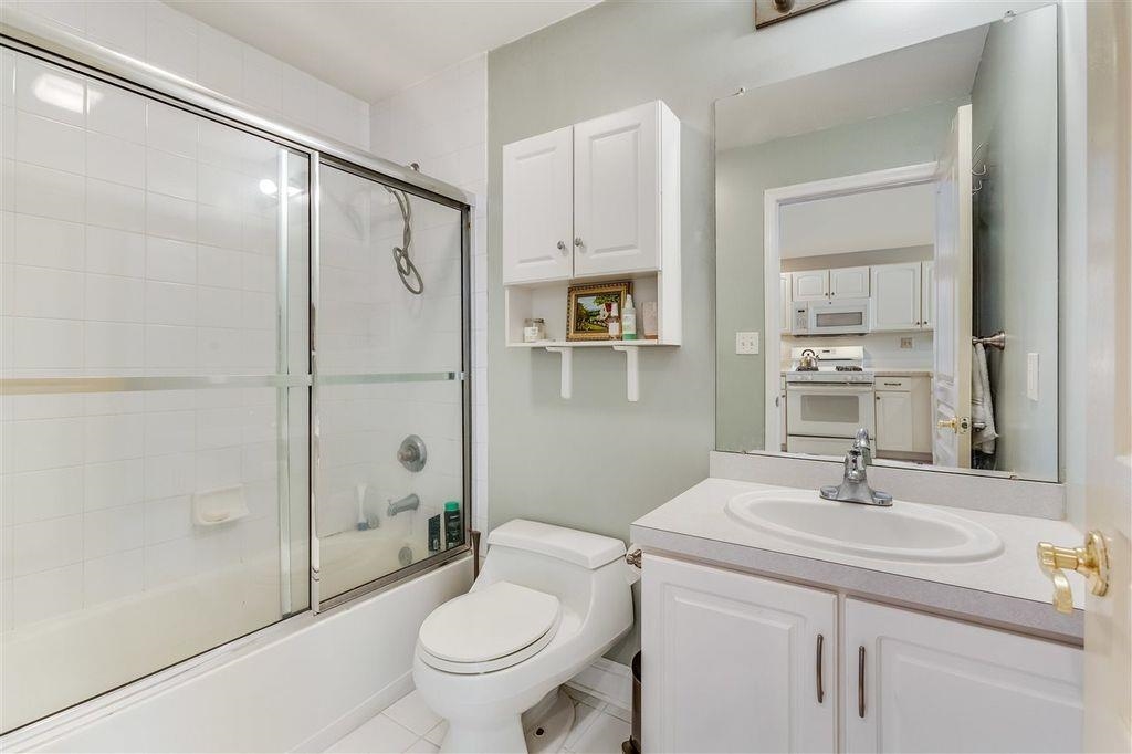 711 Clinton Street, Unit 6A Hoboken, NJ 07030 - Photo 13 of 15 a bathroom with a sink toilet and shower