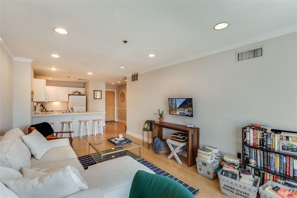 711 Clinton Street, Unit 6A Hoboken, NJ 07030 - Photo 3 of 15 a living room with furniture and a book shelf