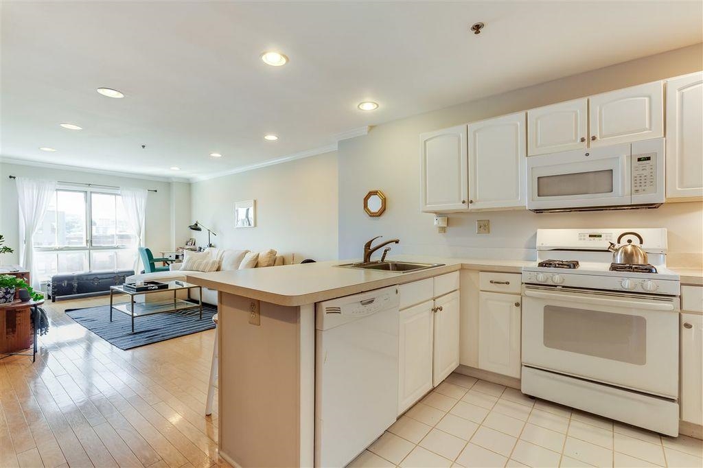 711 Clinton Street, Unit 6A Hoboken, NJ 07030 - Photo 6 of 15 a kitchen with a sink stove and cabinets