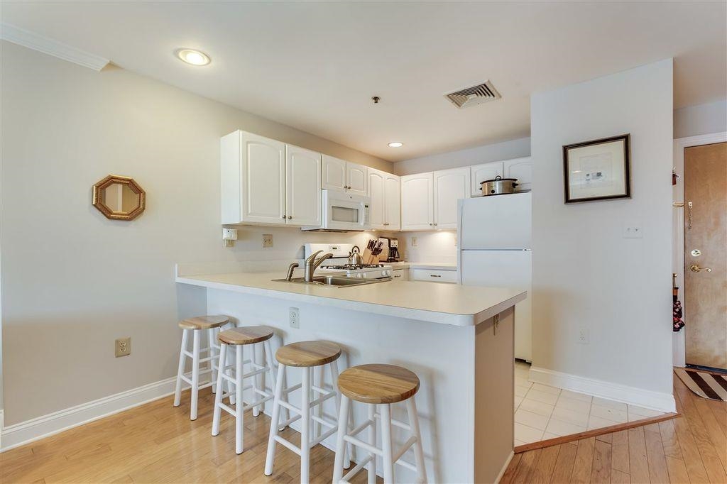 711 Clinton Street, Unit 6A Hoboken, NJ 07030 - Photo 8 of 15 a kitchen with a sink cabinets and window