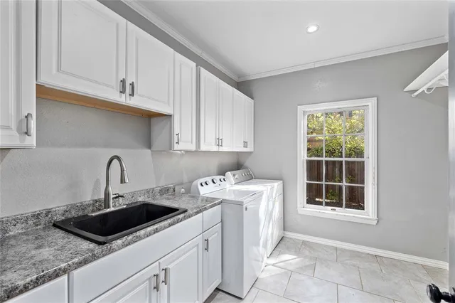 a kitchen with stainless steel appliances granite countertop a sink dishwasher a stove and a microwave oven with white cabinets