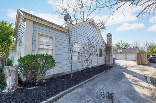 a view of a house with a yard and tree s