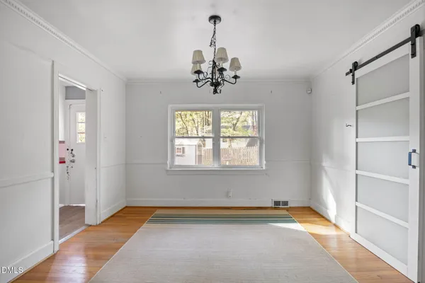 a view of a livingroom with a window and a chandelier