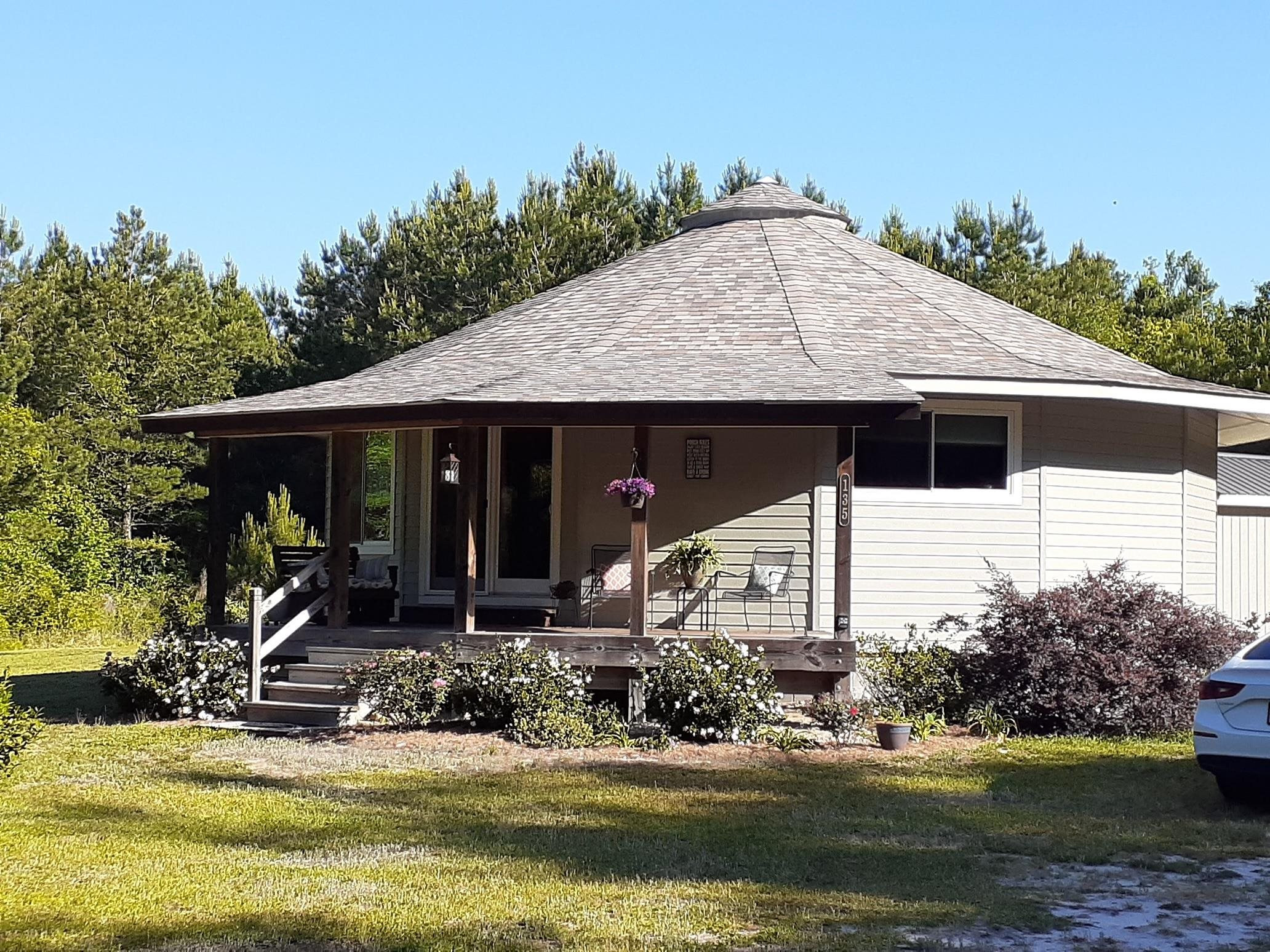 135 Barnhill Road Ivanhoe, NC 28447 - Photo 1 of 23 a front view of a house with a yard