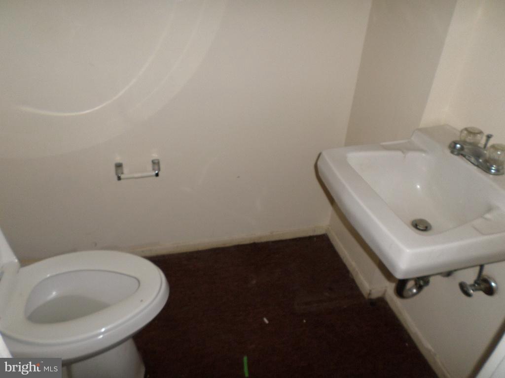 3407 Santee Road Baltimore, MD 21236 - Photo 11 of 22 a bathroom with a sink and toilet