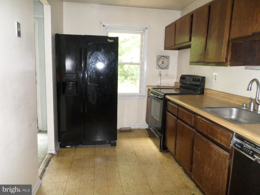 3407 Santee Road Baltimore, MD 21236 - Photo 3 of 22 a kitchen with stainless steel appliances granite countertop a refrigerator and a sink