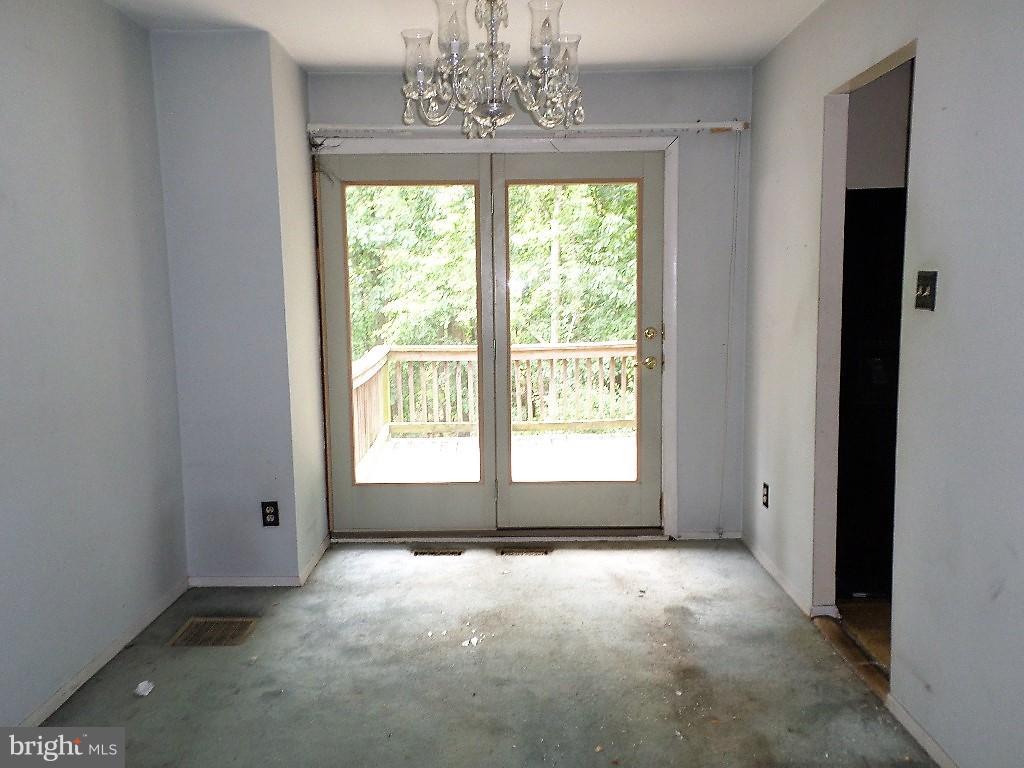 3407 Santee Road Baltimore, MD 21236 - Photo 4 of 22 a view of a livingroom with a large window and chandelier